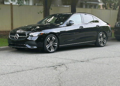 Black Mercedes-Benz C-Class with dark window tint